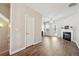 Open-concept living room featuring hardwood floors and a cozy fireplace at 3182 Mill Springs Cir, Buford, GA 30519