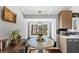 Bright breakfast nook features a built-in bench, lovely backyard views, and modern light fixture at 980 Pine Grove Pointe Dr, Roswell, GA 30075