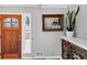 Inviting entryway featuring a beautiful wooden door, decorative art, and a stylish console at 980 Pine Grove Pointe Dr, Roswell, GA 30075