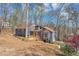 Charming gray home nestled in a wooded area, featuring a walkway and lots of natural light, with ample privacy at 980 Pine Grove Pointe Dr, Roswell, GA 30075