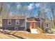 Charming gray home with a wooden walkway and a welcoming orange front door, perfect for any homeowner at 980 Pine Grove Pointe Dr, Roswell, GA 30075