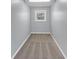 Narrow hallway with neutral walls, carpet, and a small window at 980 Pine Grove Pointe Dr, Roswell, GA 30075