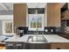 Bright kitchen featuring stainless steel appliances and a view of trees outside the windows at 980 Pine Grove Pointe Dr, Roswell, GA 30075