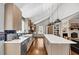 Open-concept kitchen boasts stainless appliances, quartz countertops, and a tiled backsplash at 980 Pine Grove Pointe Dr, Roswell, GA 30075