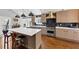Modern kitchen featuring stainless steel appliances, an island, and dark backsplash at 980 Pine Grove Pointe Dr, Roswell, GA 30075