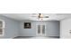 Bright living room showcasing a ceiling fan, neutral paint, cozy carpet, and access to the outdoors at 980 Pine Grove Pointe Dr, Roswell, GA 30075