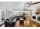 Open concept living room with vaulted ceilings, hardwood floors, and a seamless flow to the kitchen at 980 Pine Grove Pointe Dr, Roswell, GA 30075