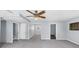 Open-concept living room with neutral walls, cozy carpet, and a ceiling fan at 980 Pine Grove Pointe Dr, Roswell, GA 30075