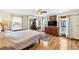 Bright main bedroom with ensuite bathroom, hardwood floors, and natural light at 980 Pine Grove Pointe Dr, Roswell, GA 30075