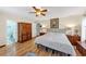 Large main bedroom with hard wood floors, ceiling fan, and ensuite bathroom at 980 Pine Grove Pointe Dr, Roswell, GA 30075