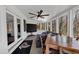 Bright sunroom with a ceiling fan, floor to ceiling windows, and a comfortable seating area at 980 Pine Grove Pointe Dr, Roswell, GA 30075