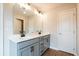 Bathroom featuring double sinks, marble countertops, gray cabinets, and modern black hardware at 105 Priestwood Ln, Acworth, GA 30102