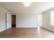 Well-lit bedroom featuring wood floors, neutral walls, and doorways leading to a closet and bathroom at 105 Priestwood Ln, Acworth, GA 30102