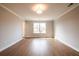 Spacious bedroom showcasing neutral colors and natural light from a single window at 105 Priestwood Ln, Acworth, GA 30102