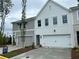 Newly built townhome with attached garage, light grey tones, and a 'For Sale' sign in the front yard at 105 Priestwood Ln, Acworth, GA 30102