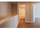 Hallway view leading to a bathroom with a shower-tub combo and another bedroom entrance at 105 Priestwood Ln, Acworth, GA 30102