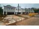 Street view of new townhomes featuring neutral siding, landscaping, and spacious driveways at 105 Priestwood Ln, Acworth, GA 30102