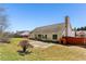 Spacious backyard featuring a stone patio, mature trees, and a partial fence line at 1703 Mission Park Dr, Loganville, GA 30052