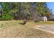 Large backyard with mature trees, shed and a partial stone patio at 1703 Mission Park Dr, Loganville, GA 30052