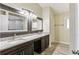Updated bathroom features a double vanity with granite counters and modern fixtures at 1703 Mission Park Dr, Loganville, GA 30052