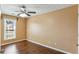 Bedroom with wood floors, a ceiling fan, and a window at 1703 Mission Park Dr, Loganville, GA 30052