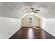 Cozy bedroom with hardwood floors, a ceiling fan, and textured ceilings at 1703 Mission Park Dr, Loganville, GA 30052