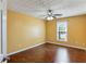 This bedroom features hardwood floors and a ceiling fan at 1703 Mission Park Dr, Loganville, GA 30052