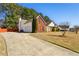 Charming home with a long driveway leading to a two-car garage, all set against a wooded backdrop at 1703 Mission Park Dr, Loganville, GA 30052