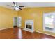 Bright and inviting living room featuring a fireplace, hardwood floors, and two large windows at 1703 Mission Park Dr, Loganville, GA 30052