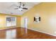 Bright living room with wood floors, a ceiling fan, and a pass-through to the kitchen at 1703 Mission Park Dr, Loganville, GA 30052