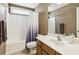 Bathroom featuring a toilet, shower with curtain, light wood cabinets and white sink at 173 Northshore Xing, Dallas, GA 30157