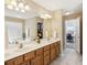 Bathroom with double sink vanity, soaking tub, and separate walk-in closet at 173 Northshore Xing, Dallas, GA 30157
