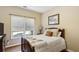 Bedroom with plush bed, throw blanket and pillows in front of a large bright window at 173 Northshore Xing, Dallas, GA 30157