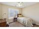 Cozy bedroom showcasing a single bed, side table with lamp, and a window at 173 Northshore Xing, Dallas, GA 30157