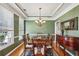 Elegant dining room featuring coffered ceilings, wainscoting, hardwood floors, and a chandelier at 173 Northshore Xing, Dallas, GA 30157