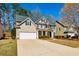 Charming two-story home featuring a two-car garage, manicured lawn, and inviting facade at 173 Northshore Xing, Dallas, GA 30157