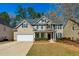 Charming two-story home featuring a manicured lawn and a classic architectural design at 173 Northshore Xing, Dallas, GA 30157