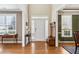 Inviting foyer with hardwood floors, a bench with coat rack, and views into the dining and living room at 173 Northshore Xing, Dallas, GA 30157