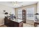 Office space featuring a large wooden desk, grandfather clock, and two windows with natural light at 173 Northshore Xing, Dallas, GA 30157