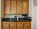 View of the kitchen with dark granite countertops and wooden cabinets at 173 Northshore Xing, Dallas, GA 30157