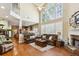 Bright and spacious living room featuring soaring ceilings, a fireplace, hardwood floors, and an open floor plan at 173 Northshore Xing, Dallas, GA 30157