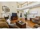 Comfortable living room showcasing a fireplace, large windows, hardwood floors, and an open layout at 173 Northshore Xing, Dallas, GA 30157