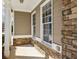 Covered porch area with stone accents, offering a charming outdoor seating space at 173 Northshore Xing, Dallas, GA 30157