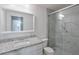 A modern bathroom with a granite countertop, framed mirror, and updated shower at 320 Park Ridge Cir, Marietta, GA 30068