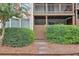 View of building with fenced in patios, manicured shrubbery, and pink crepe myrtle at 320 Park Ridge Cir, Marietta, GA 30068
