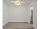 Empty dining room features wood-look floors, ceiling fan, and access to kitchen at 320 Park Ridge Cir, Marietta, GA 30068