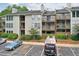 Apartment exterior featuring multiple balconies, professionally landscaped grounds, and parking at 320 Park Ridge Cir, Marietta, GA 30068