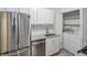 Kitchen featuring stainless steel appliances, sink, cabinets, subway tile backsplash and laundry closet at 320 Park Ridge Cir, Marietta, GA 30068