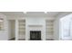 Living room showcasing wood-look floors, a fireplace, and built-in shelving at 320 Park Ridge Cir, Marietta, GA 30068