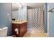 Well-appointed bathroom featuring a vanity with granite countertops and a shower with decorative curtain at 3324 Peachtree Ne Rd # 814, Atlanta, GA 30326